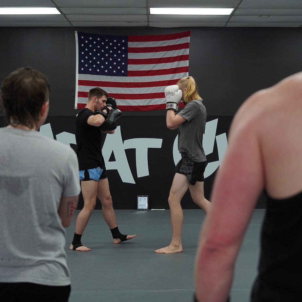 Two men demonstrating muay thai punches at rogue combat club in Asheville, North Carolina