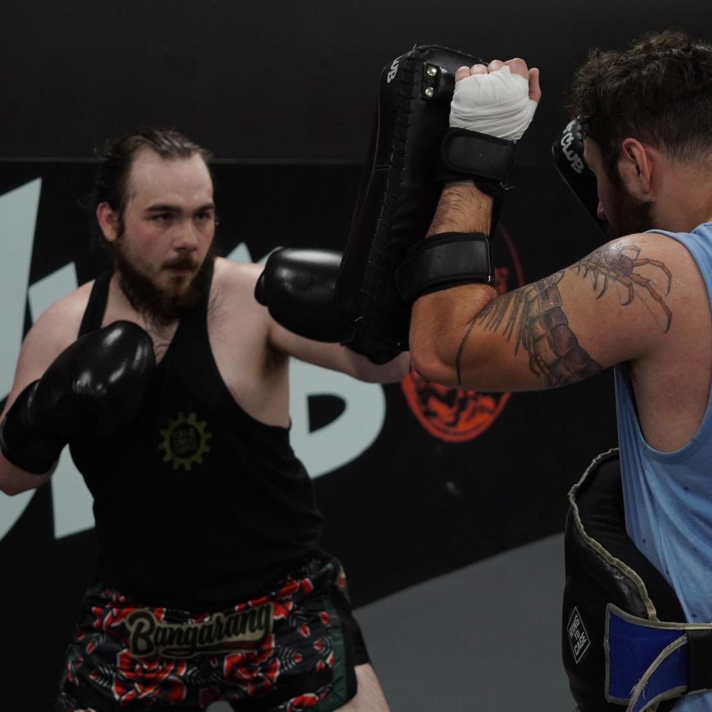 two men practicing muay thai at rogue combat club in Asheville, North Carolina