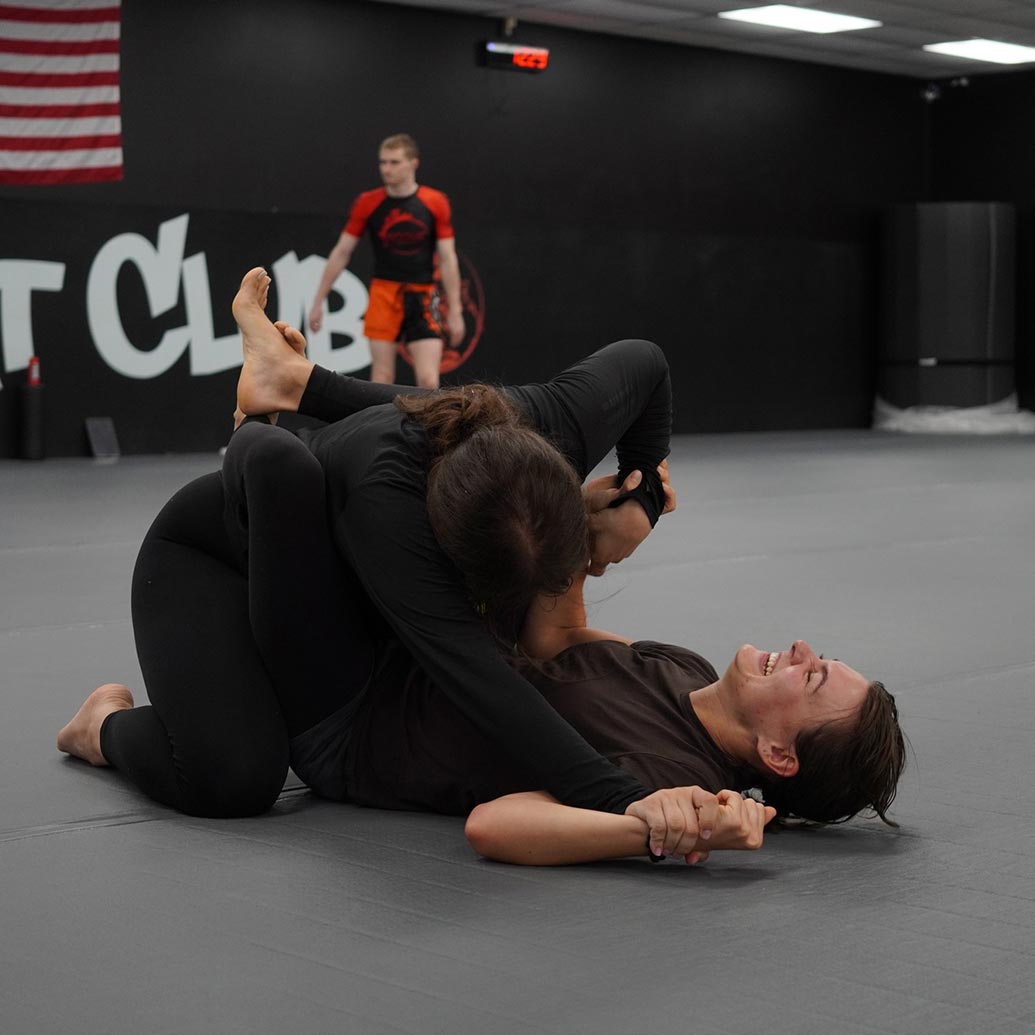 two women at rogue combat club grappling and practicing BJJ